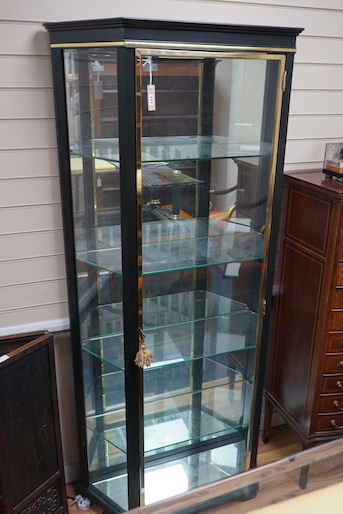 A brass mounted black painted display cabinet with interior lighting, width 92cm, depth 34cm, height 195cm